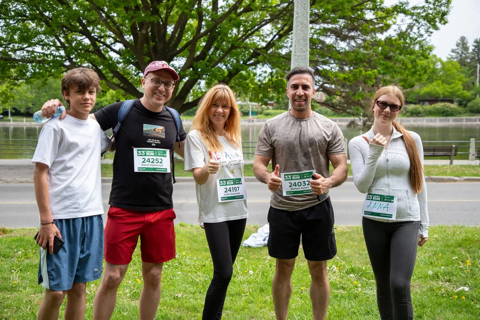 Chestnut Run participants in race bibs by the water in Ottawa before the start