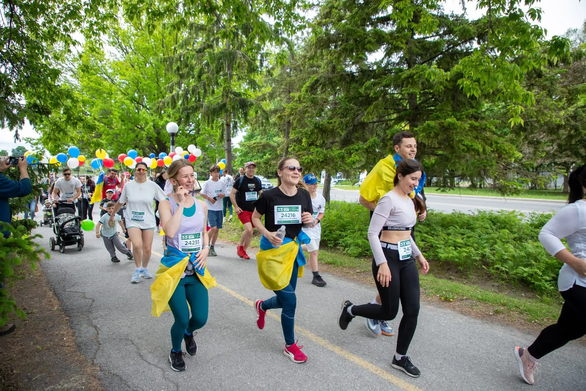 Runners with Ukrainian flags along the canal at Chestnut Run Ottawa
