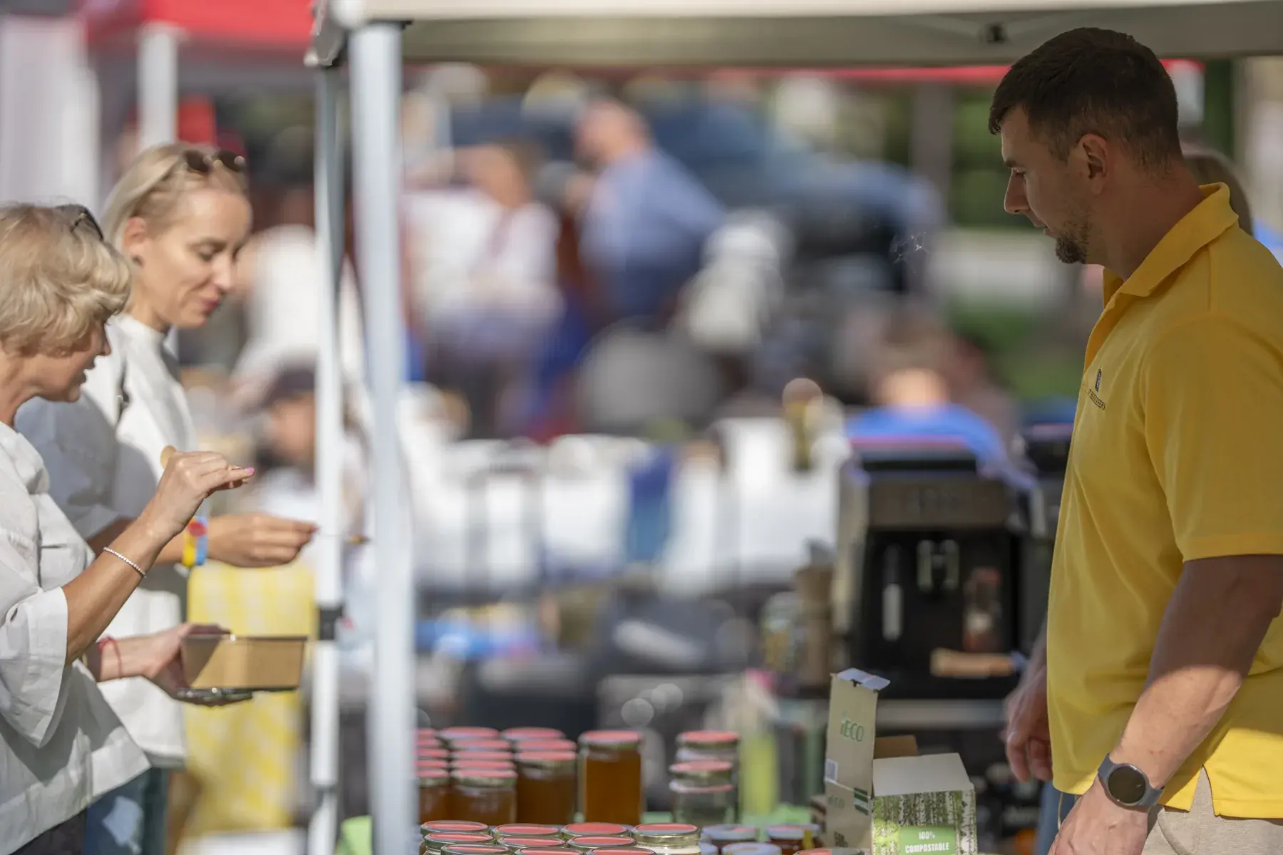 Oleh Haiduk at UAFest 2026 — Honey stall with jars on display and shoppers (photo: Tim Skinner)
