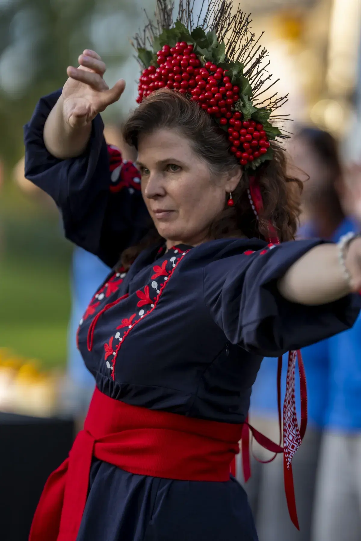 Oksana Pikush at UAFest 2026 — Woman in viburnum wreath and embroidered dress dances with arms spread (photo: Tim Skinner)
