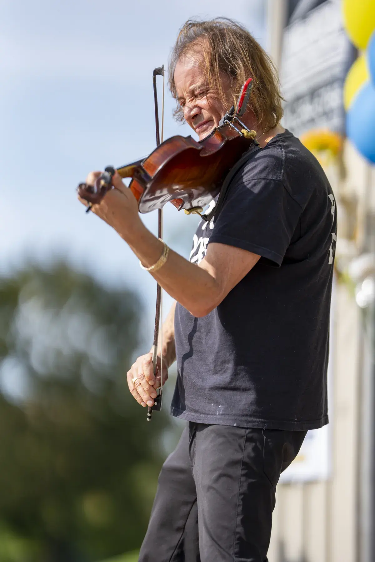 Vasyl Popadiuk at UAFest 2026 — Violinist plays on stage beside yellow and blue balloons (photo: Tim Skinner)