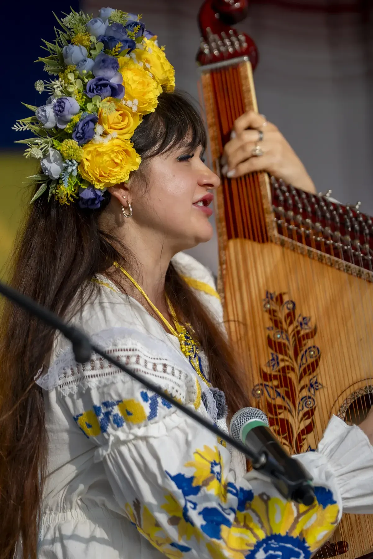 Lidiia Hurinenko at UAFest 2026 — Bandura player in a vyshyvanka and flower crown singing and playing (photo: Tim Skinner)