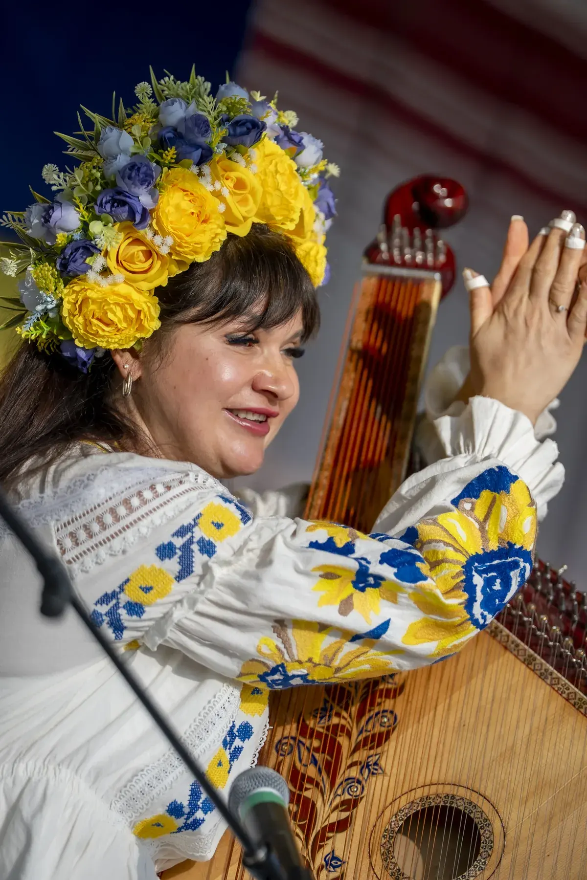 Lidiia Hurinenko at UAFest 2026 — Bandura player clapping and smiling on stage (photo: Tim Skinner)