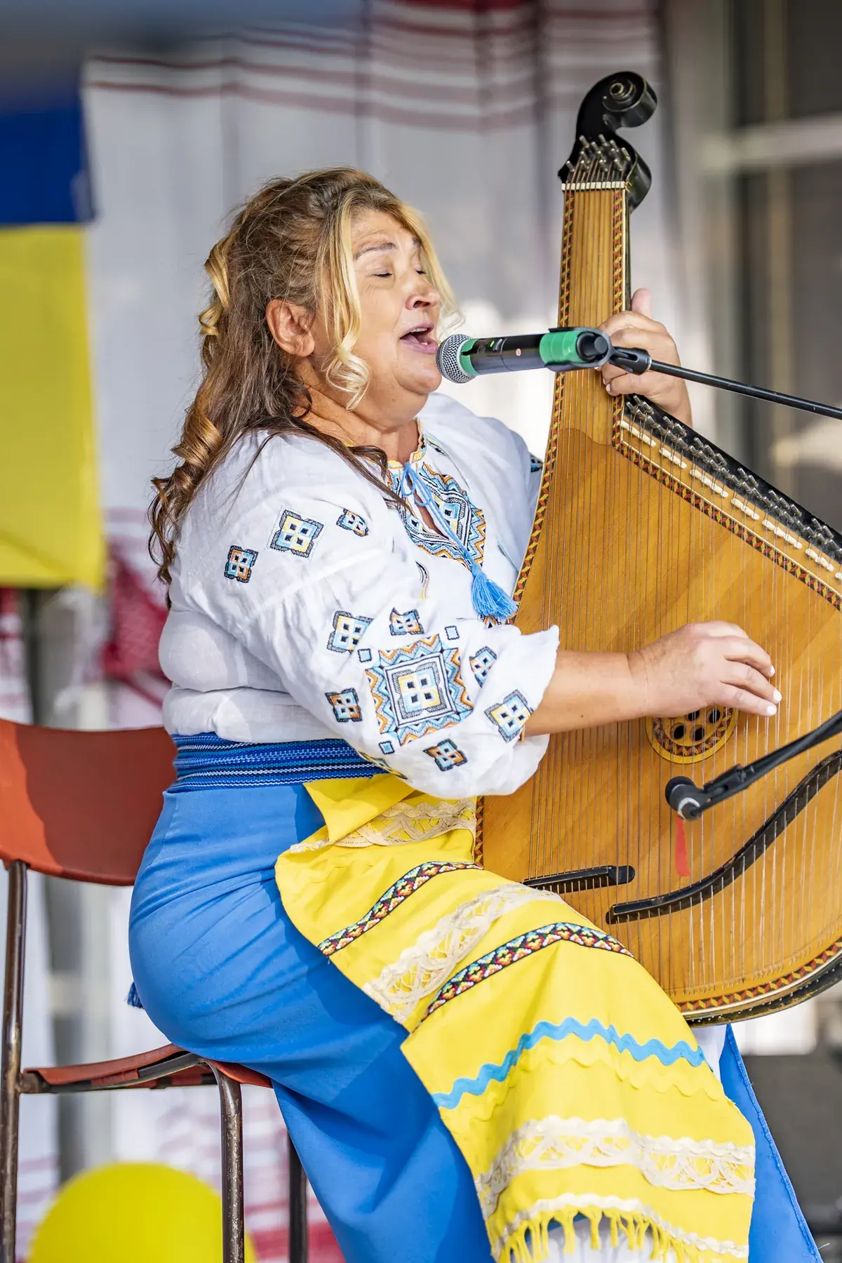 Tanya Navolska at UAFest 2026 — Woman in Ukrainian costume sings and plays the bandura on stage (photo: Tim Skinner)