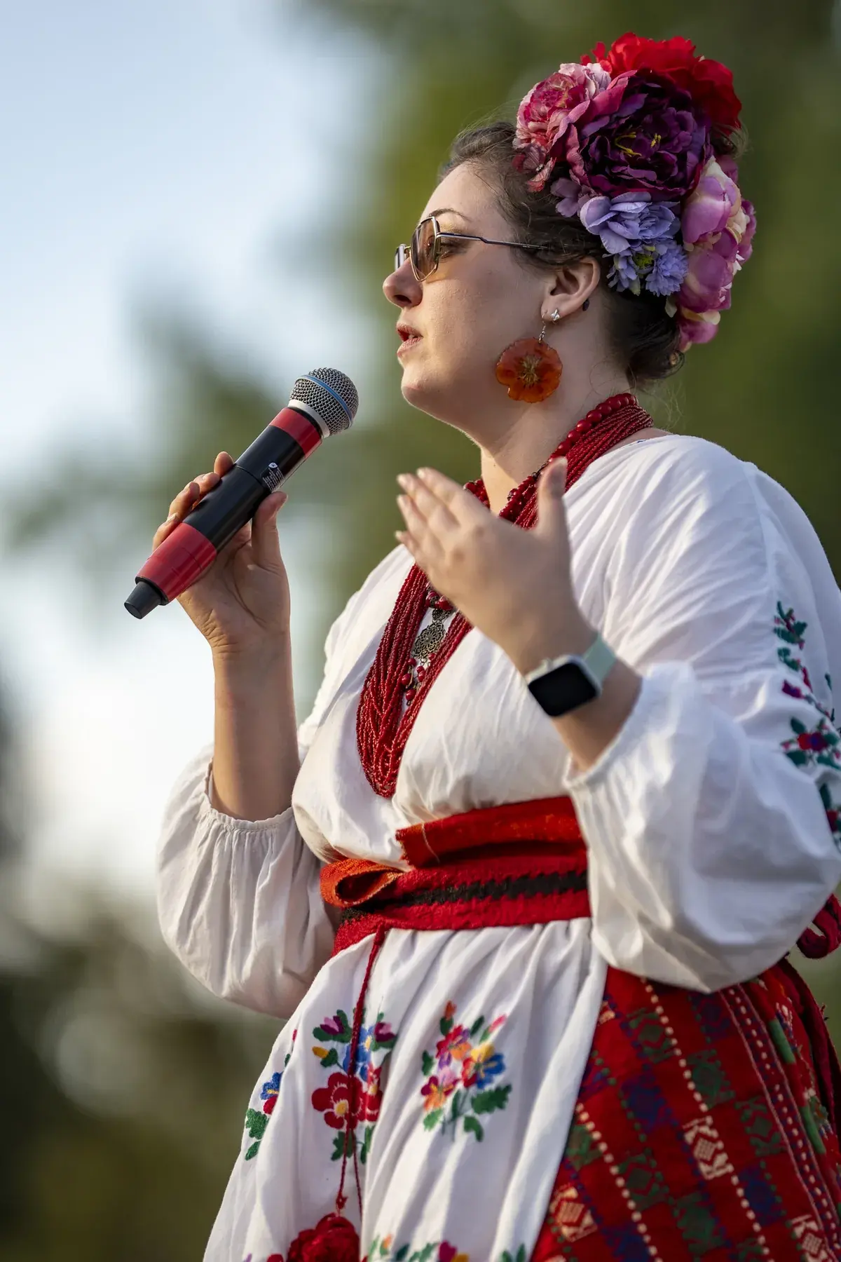 Olga Ostafiichuk at UAFest 2026 — Host in an embroidered costume and flower headdress speaks into a microphone (photo: Tim Skinner)