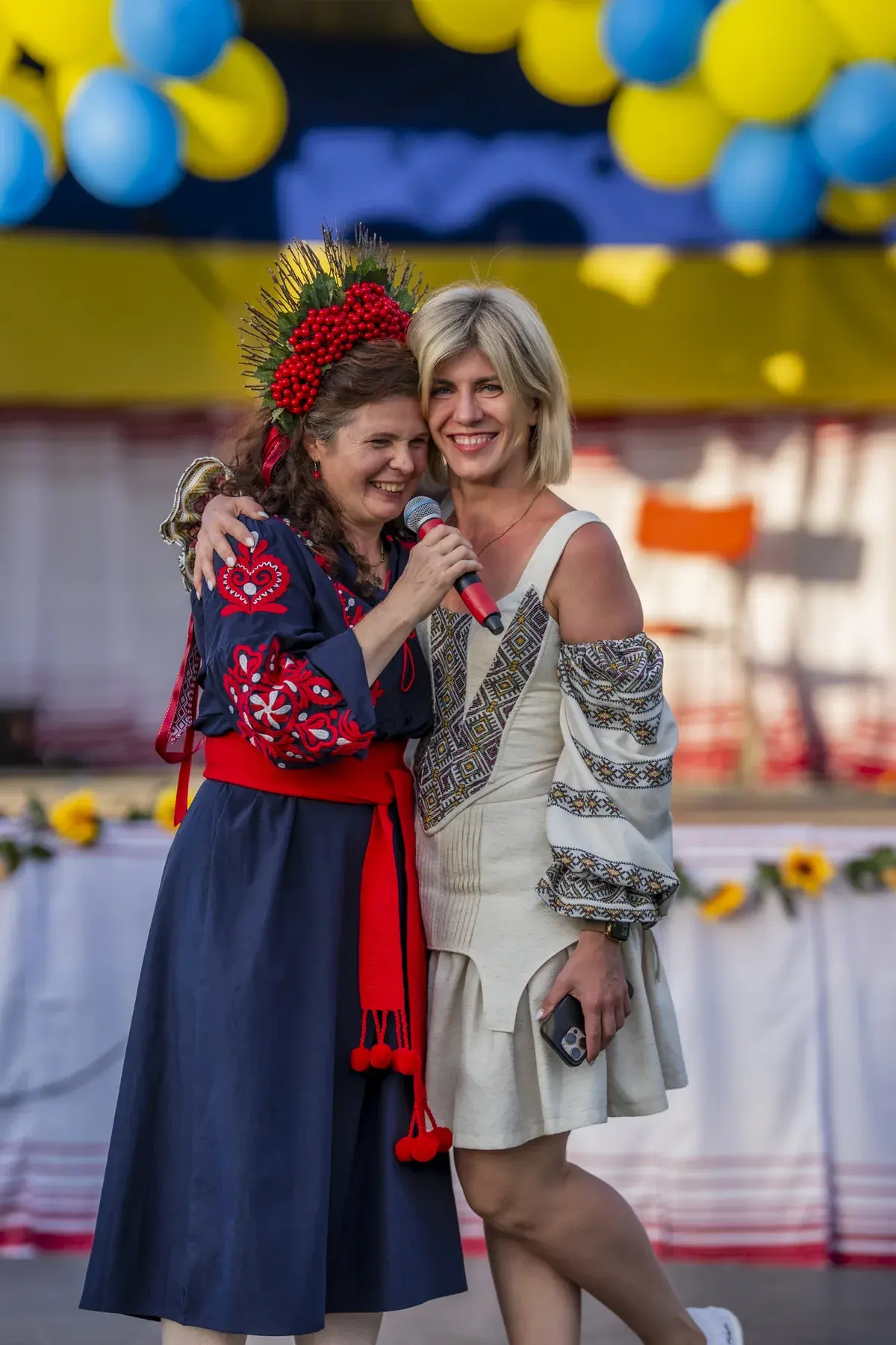 Oksana Pikush at UAFest 2026 — Two women in embroidered dresses embrace on stage (photo: Tim Skinner)
