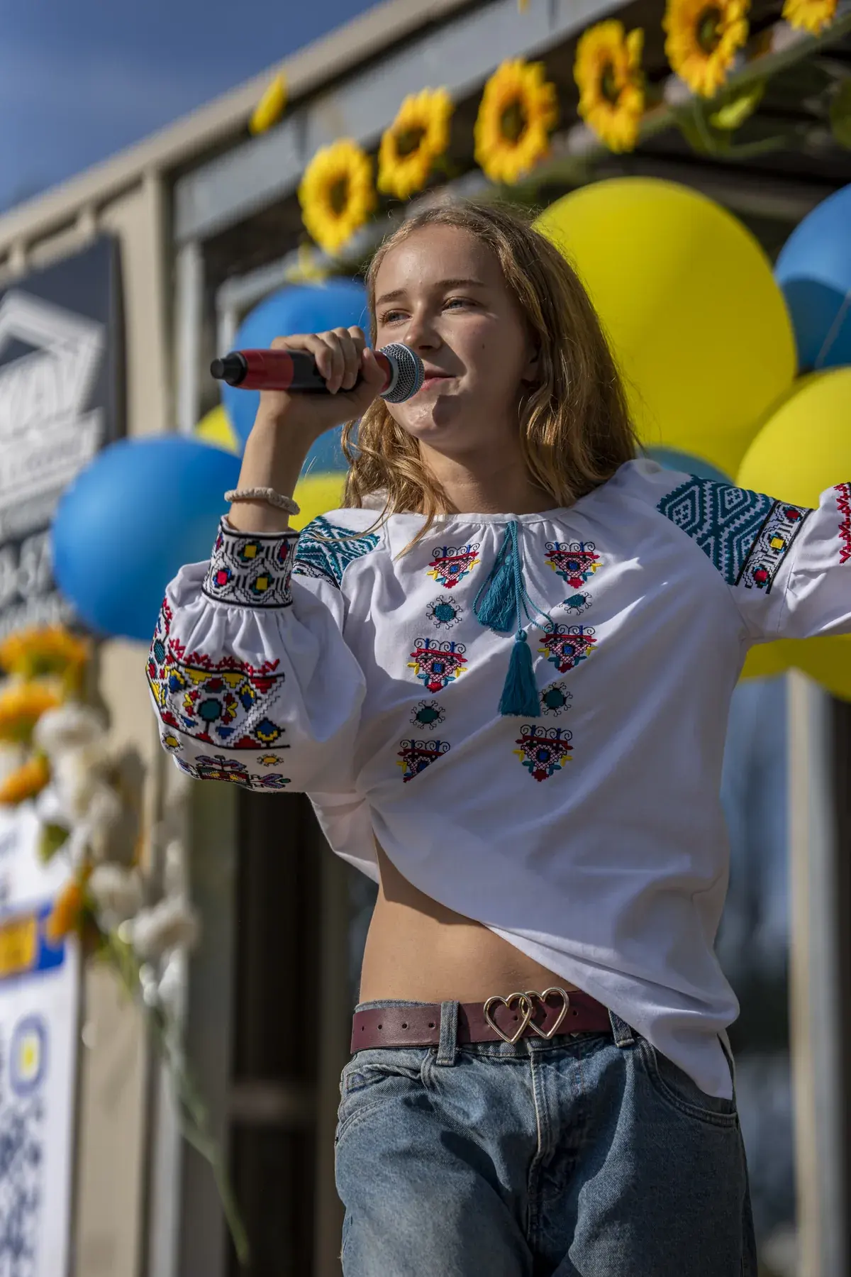 Marta Stepanenko at UAFest 2026 — Teen singer in a Ukrainian embroidered blouse performs on stage (photo: Tim Skinner)