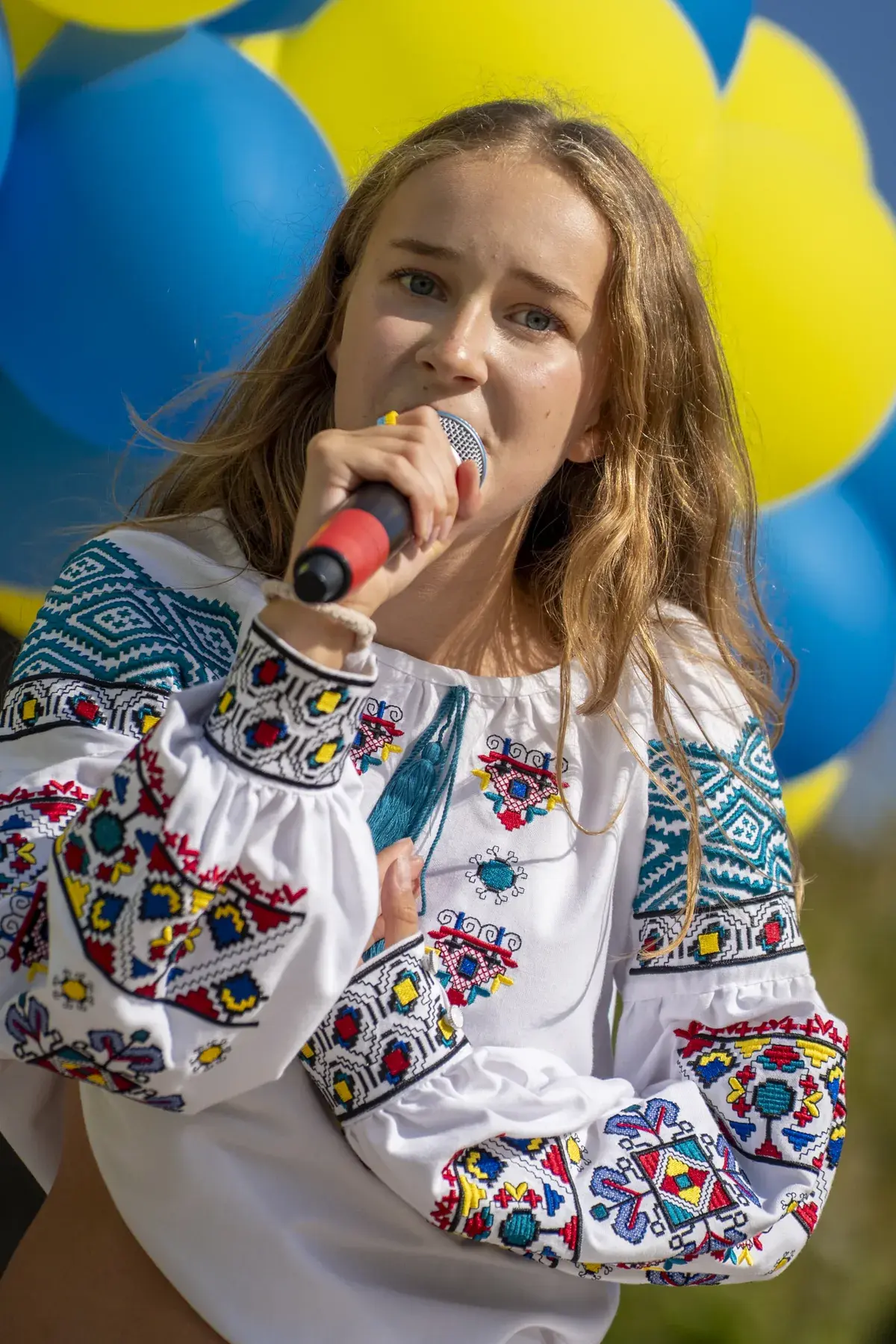 Marta Stepanenko at UAFest 2026 — Teen singer in a Ukrainian embroidered blouse performs on stage (photo: Tim Skinner)