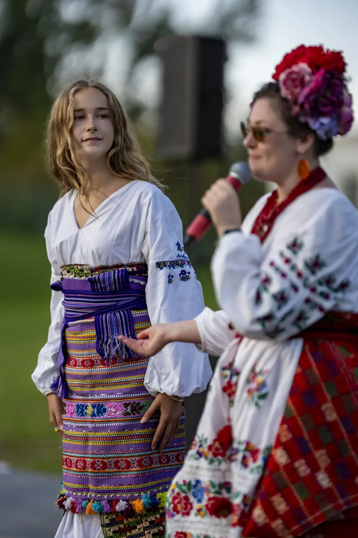 Olga Ostafiichuk at UAFest 2026 — Host in a flower headdress presents a girl in a traditional costume (photo: Tim Skinner)