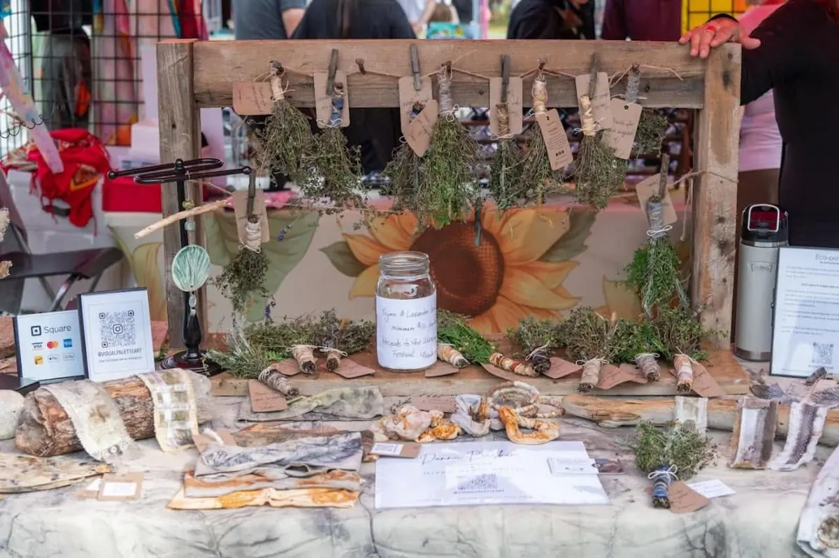A market stall with herbs and handmade goods at the festival