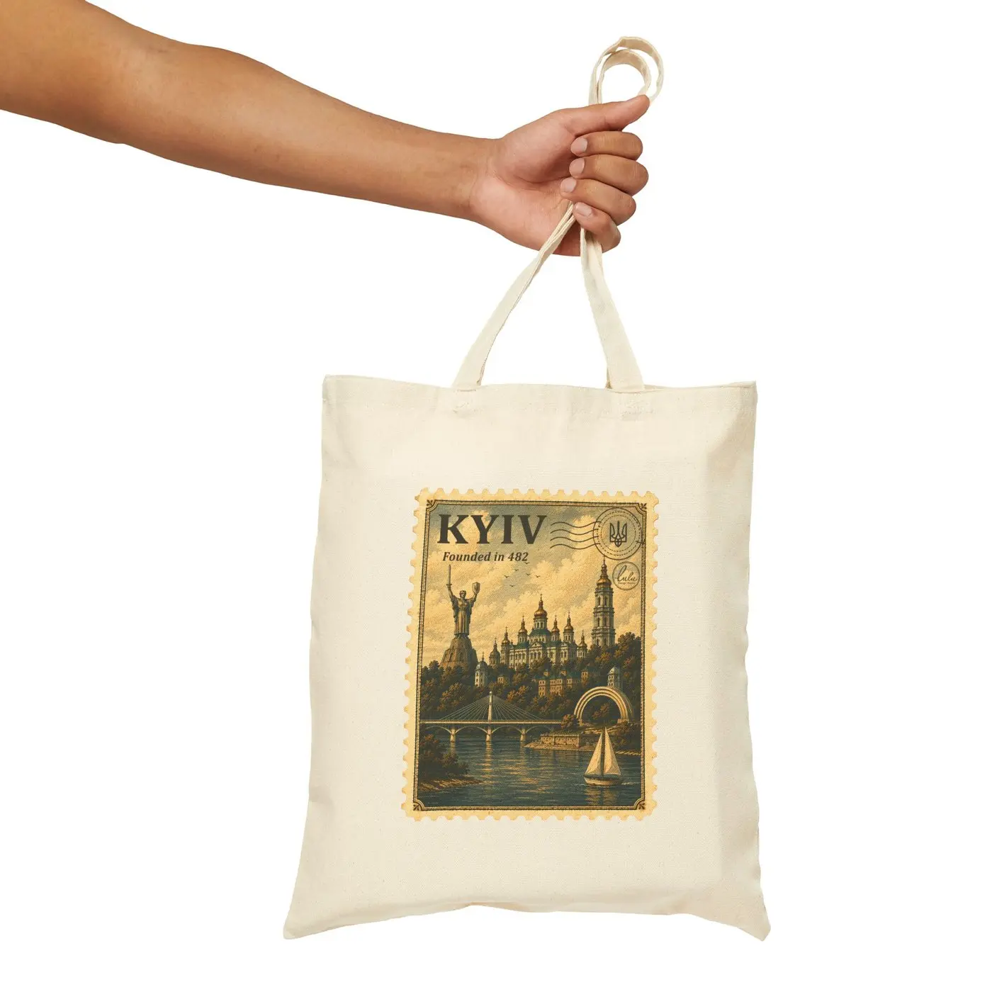 A hand holding the tote by its handles against a plain background