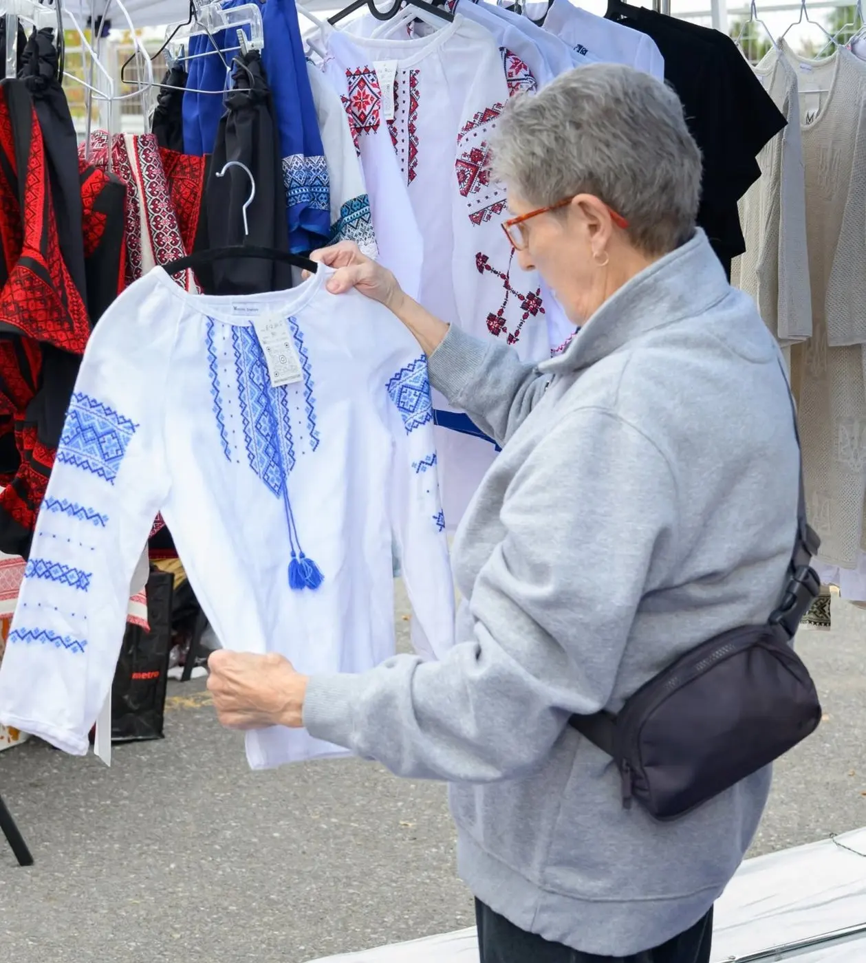A rack of embroidered vyshyvanky at a clothing stall on the market row