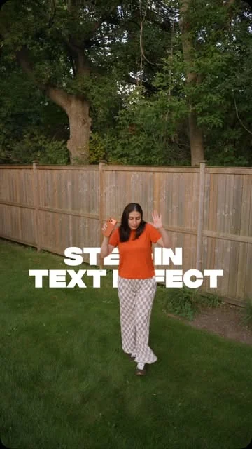 A woman in an orange top walking on grass in front of a wooden fence, with the words "STEP-IN TEXT EFFECT" set across the frame