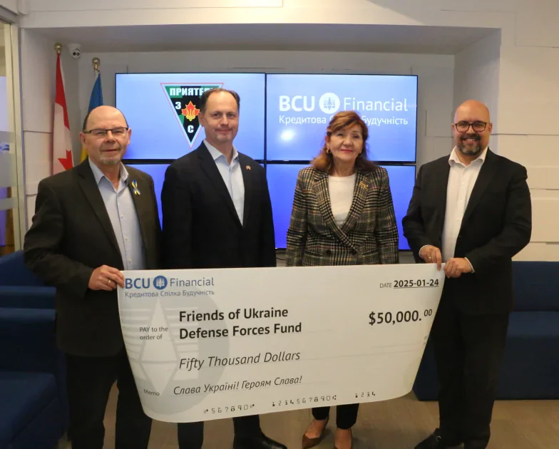 Four people holding an oversized BCU Financial cheque made out to the Friends of Ukraine Defense Forces Fund, with Canadian and Ukrainian flags behind them