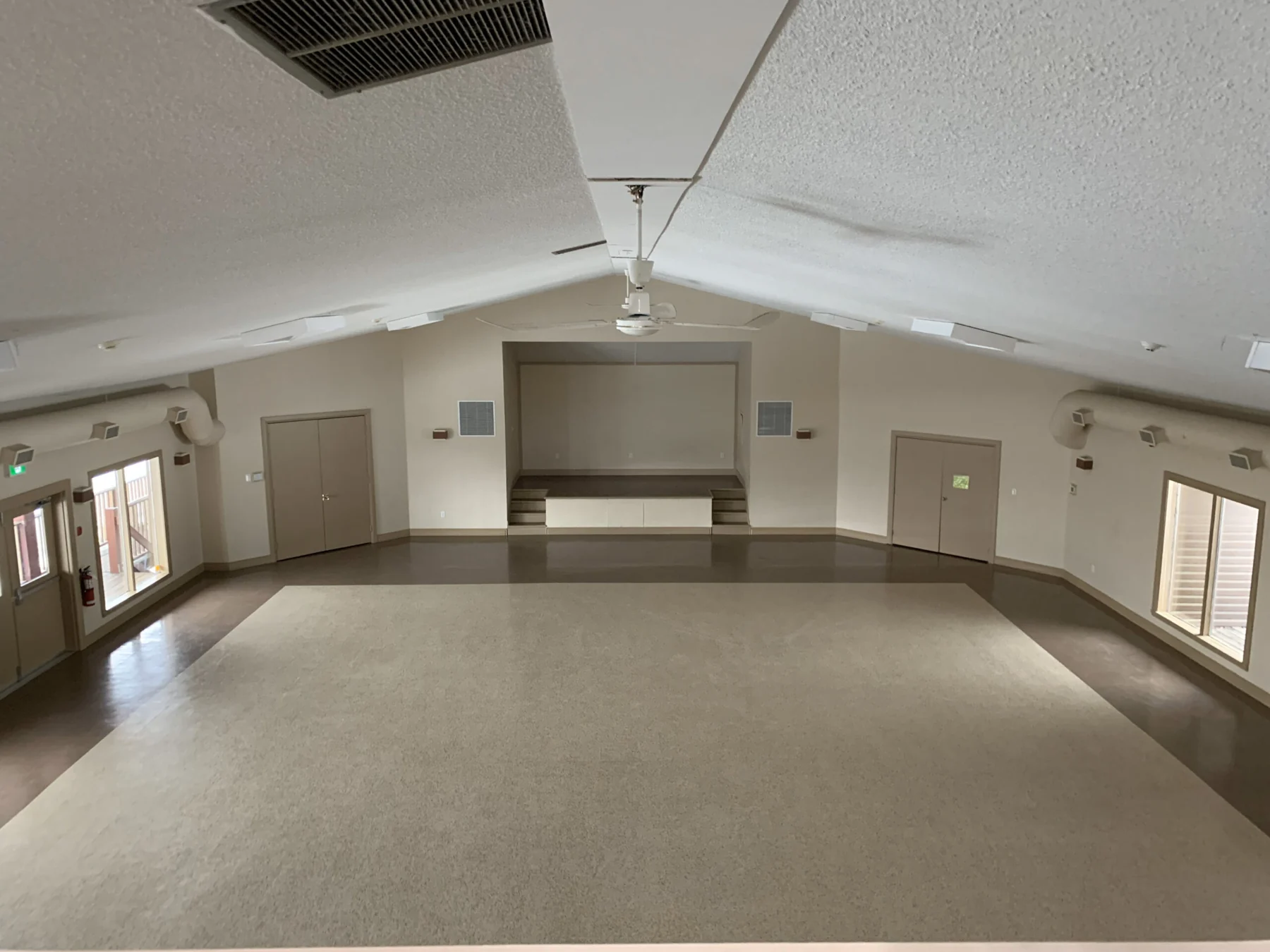 The hall at the Canoe Club, empty, with a stage at one end