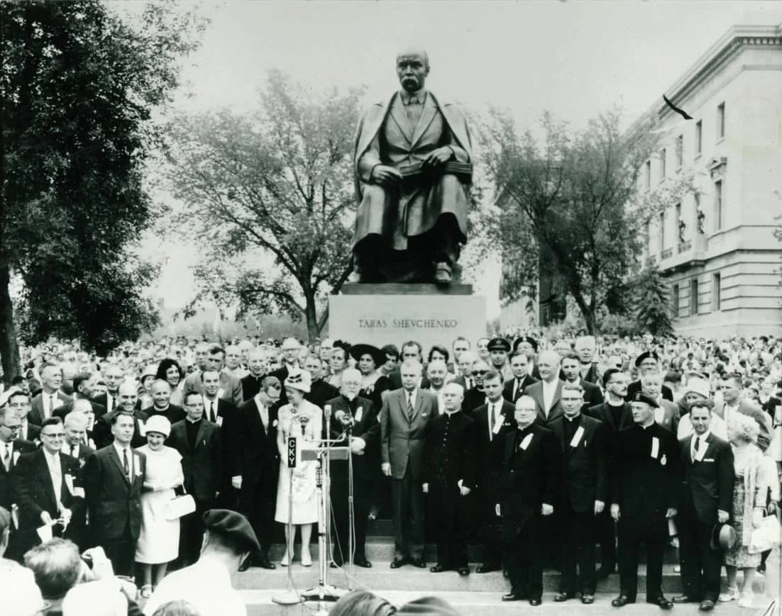 Black-and-white photograph of the 1961 unveiling of the Taras Shevchenko monument at the Manitoba Legislature, a crowd and clergy standing on the steps below the seated bronze figure