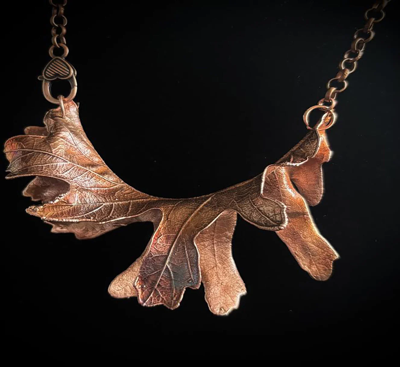 Oak Leaf Symphony — a copper oak-leaf necklace, several leaves fanned across a copper chain, with an antique finish
