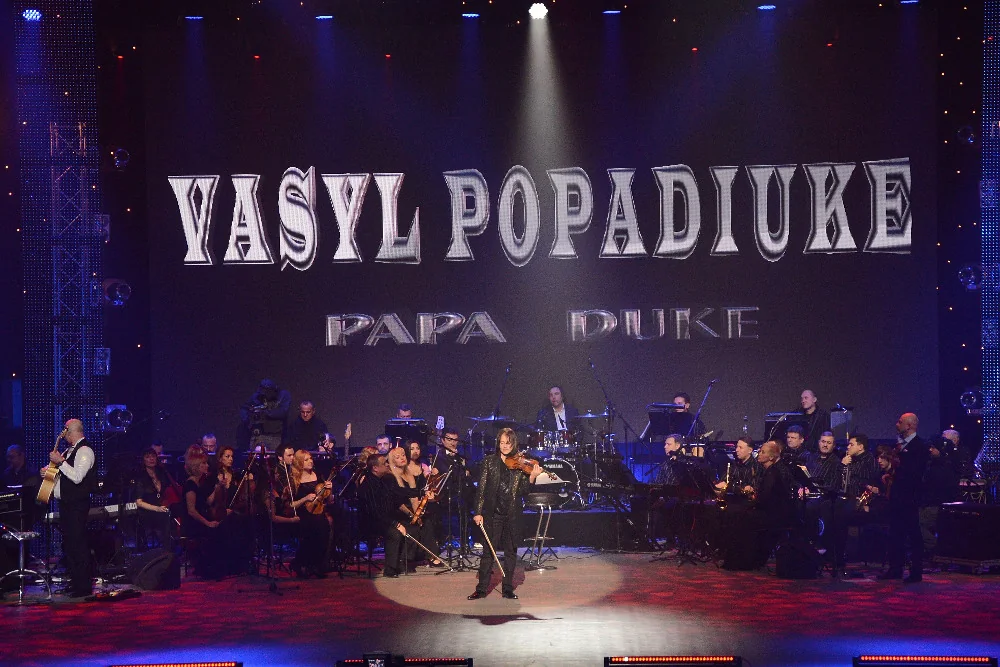 Vasyl Popadiuk and Papa Duke with a full orchestra, his name on the screen above the stage
