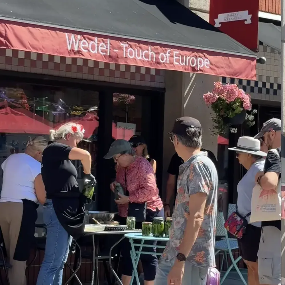 The Wedel shop under its red awning at 5 ByWard Market Square, with tables out on the square